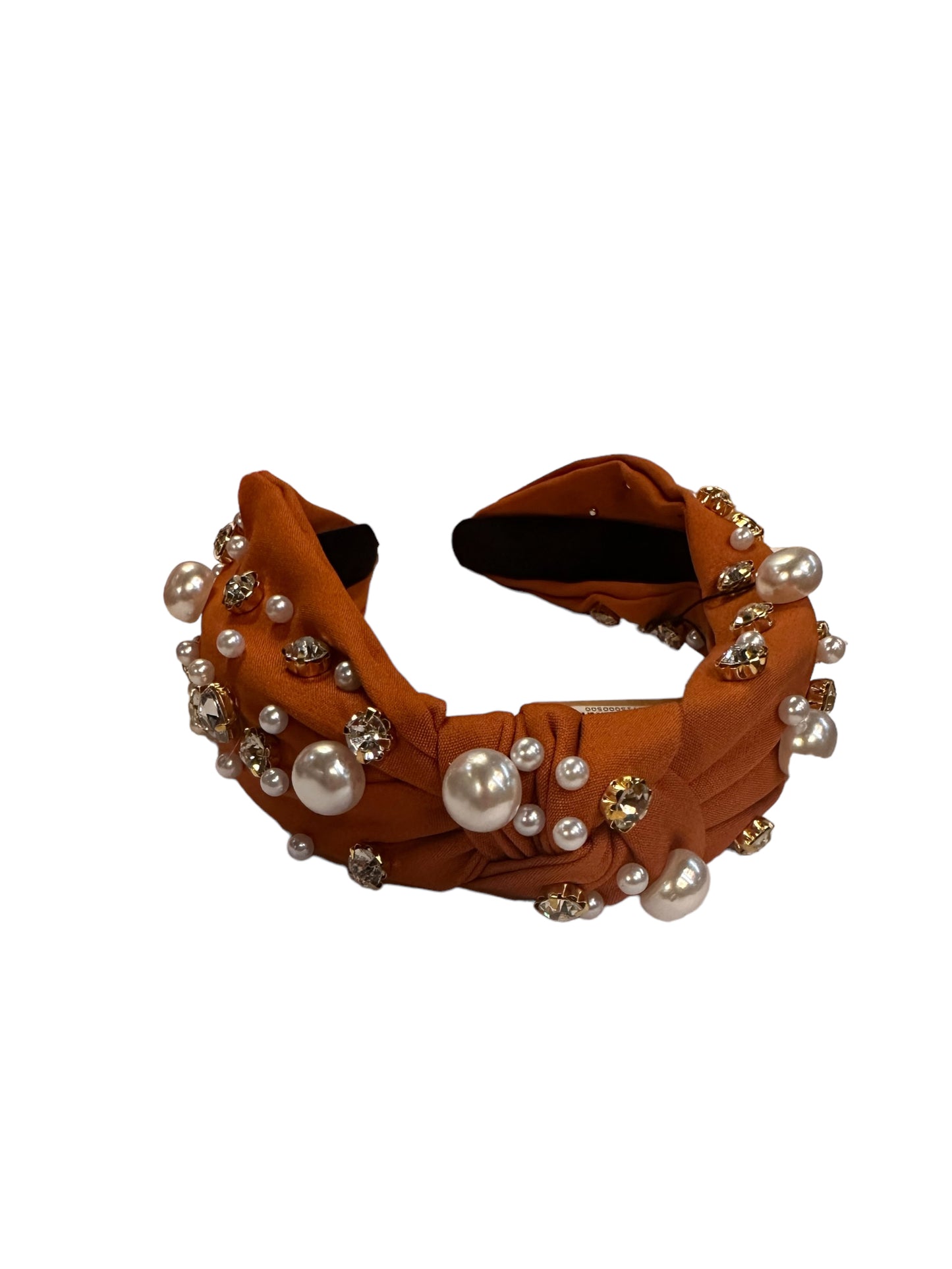 Rust satin headband with faux pearls, gold rhinestones, and twisted knot design. Available in standard size.
