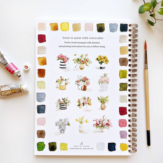 The Bouquets Watercolor Workbook, spiral-bound and open to floral exercises; available in standard workbook size.