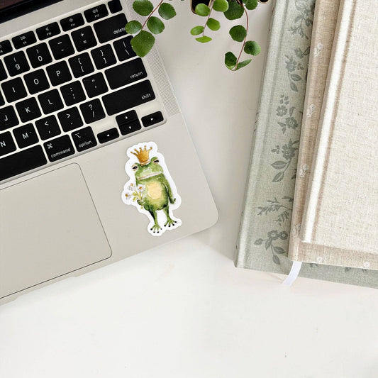 Laptop with Frog prince sticker next to keyboard. Available in 13", 15", and 17" sizes.