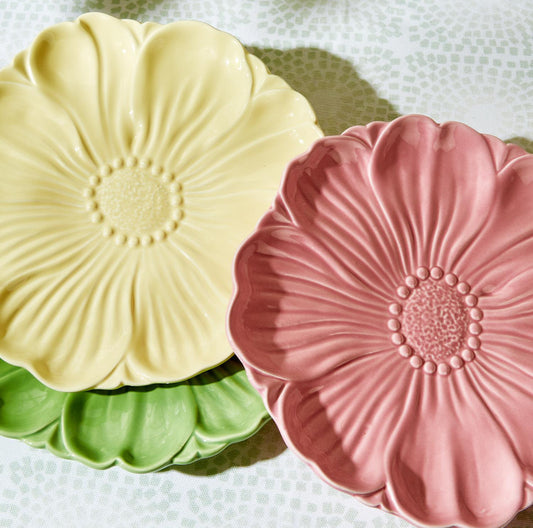 Set of three ceramic Flora Flower Accent Dishes in pastel yellow, pink, and green with raised floral designs. Sizes: small, medium, large.