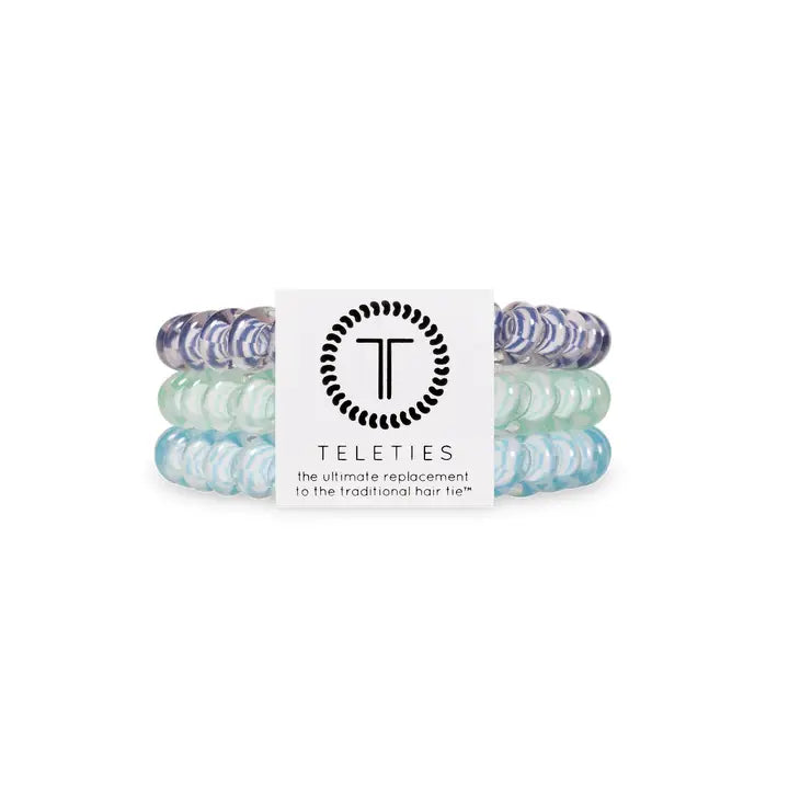 Three TELETIES Hair Ties in purple, mint green, and light blue stacked together; available in small and large sizes.