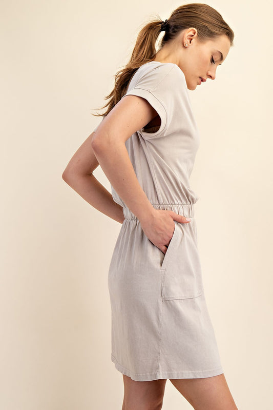 Mineral Washed Elastic Waist Cotton Dress: Light beige mini dress with a relaxed silhouette, elastic waistband, and side pockets. Sizes available: S, M, L.