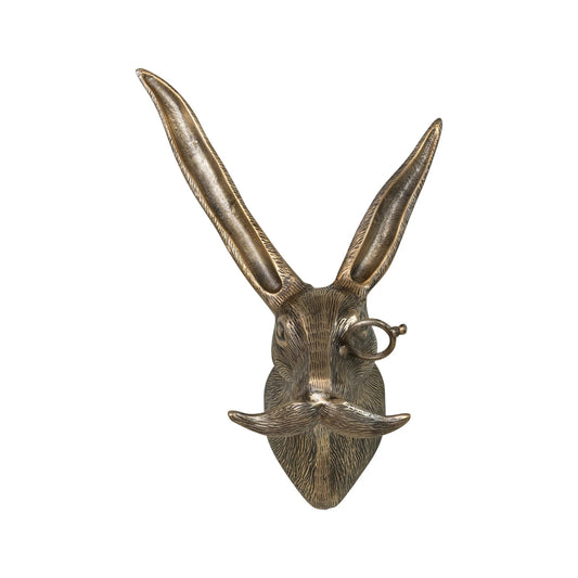 Wall-mounted rabbit sculpture with long ears, curled mustache, monocle; cast aluminum, antique brass finish. Sizes: S, M, L.