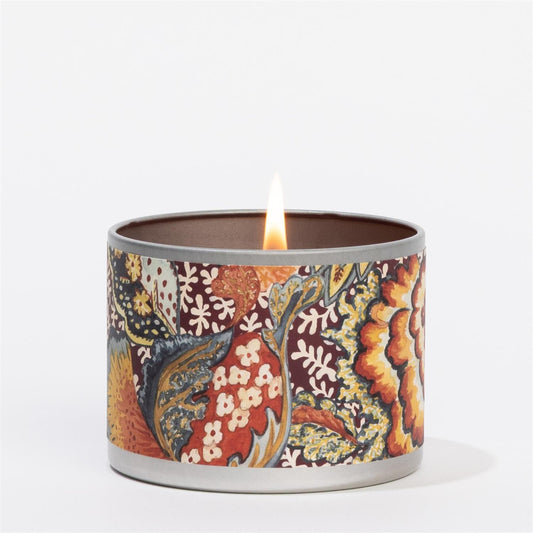 The Hope Tin Candle is a round tin with a floral design in orange, red, yellow, and blue on white; sizes available.