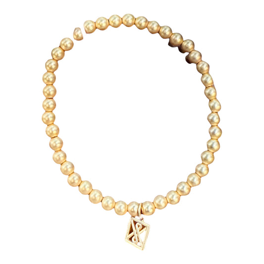 Matte Gold Bracelet with round matte gold beads and infinity charm. Adjustable stretch fit. Sizes: S, M, L.
