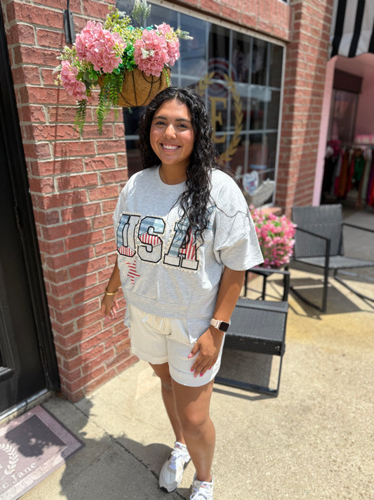 USA Patch Tee in white, featuring bold patch detail; available in sizes S-XL.