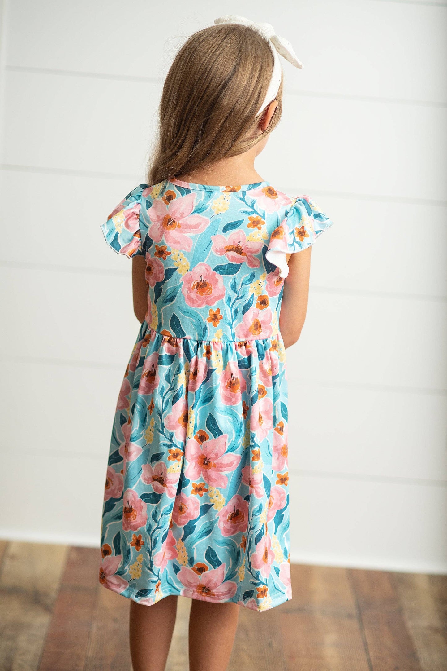 Girls Claire Pink Floral Print Twirl Dress, available in sizes 2T-10. Features pink floral pattern and twirl-ready skirt.