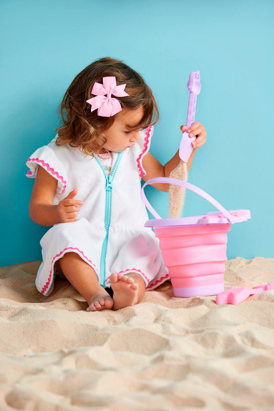 Toddler Zip Cover-Up: A white dress with pink accents. Sizes available: 12M, 18M, 24M, 2T, 3T, 4T, and 5T.