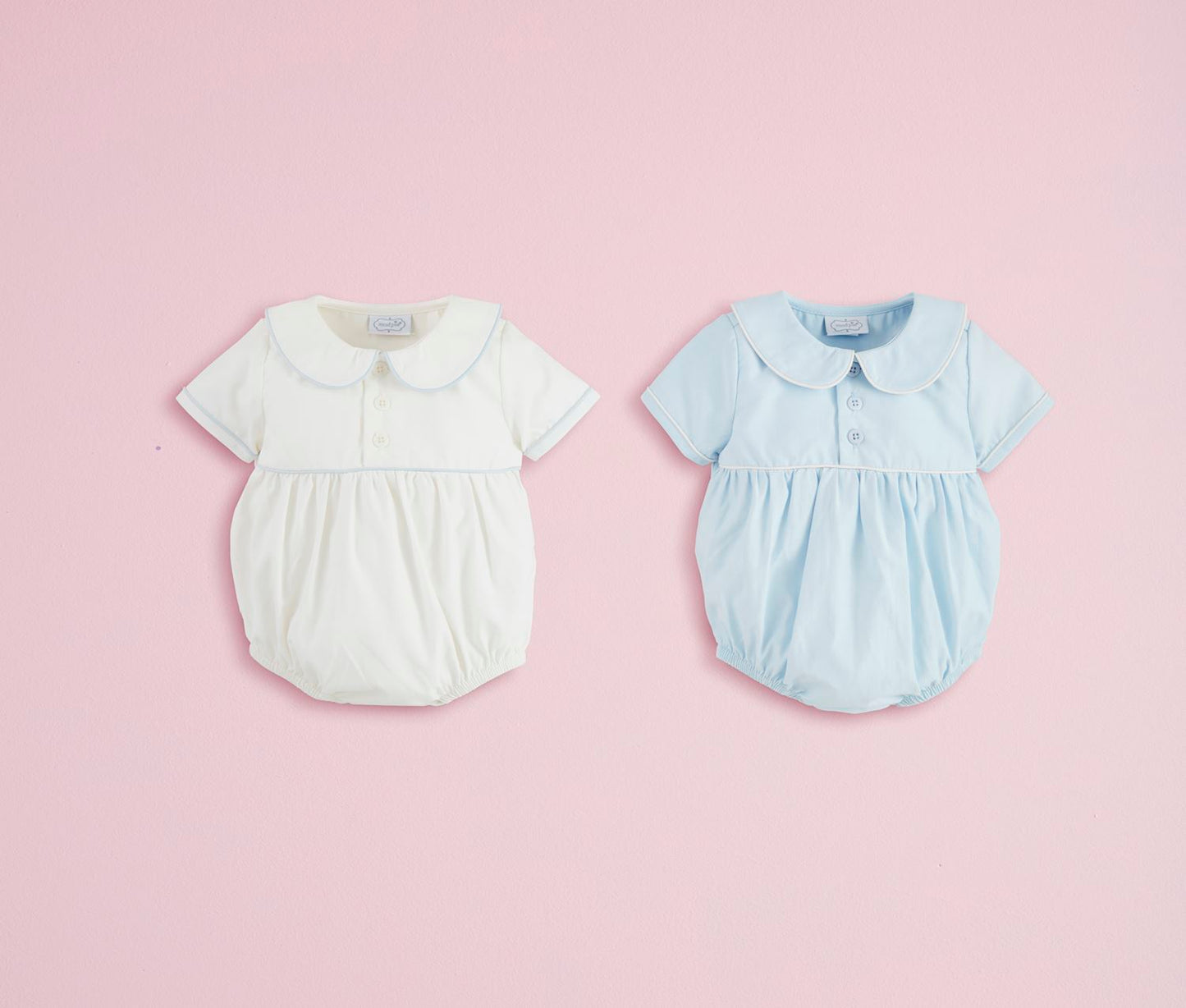 Two collared poplin baby bubbles in white and light blue with Peter Pan collars, short sleeves. Sizes: NB-24M.