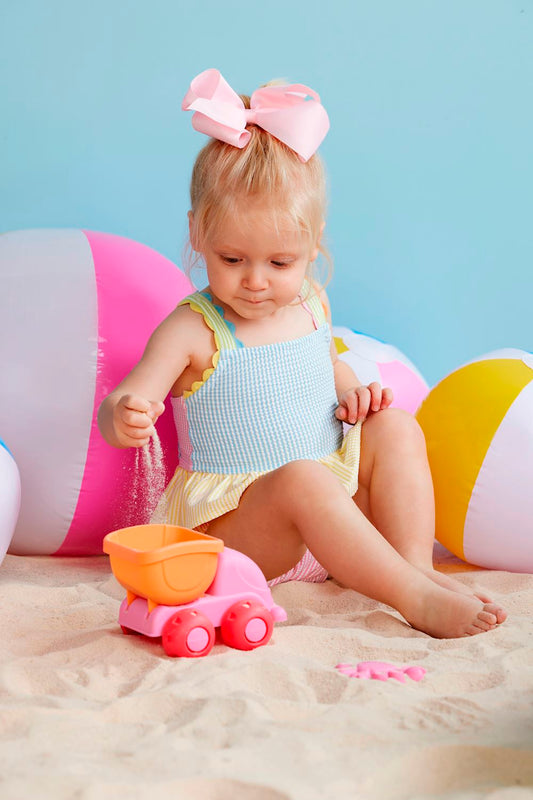Girls' Seersucker Ric Rac Swimsuit with pink bow. Available sizes: 2T, 3T, 4T, 5T.