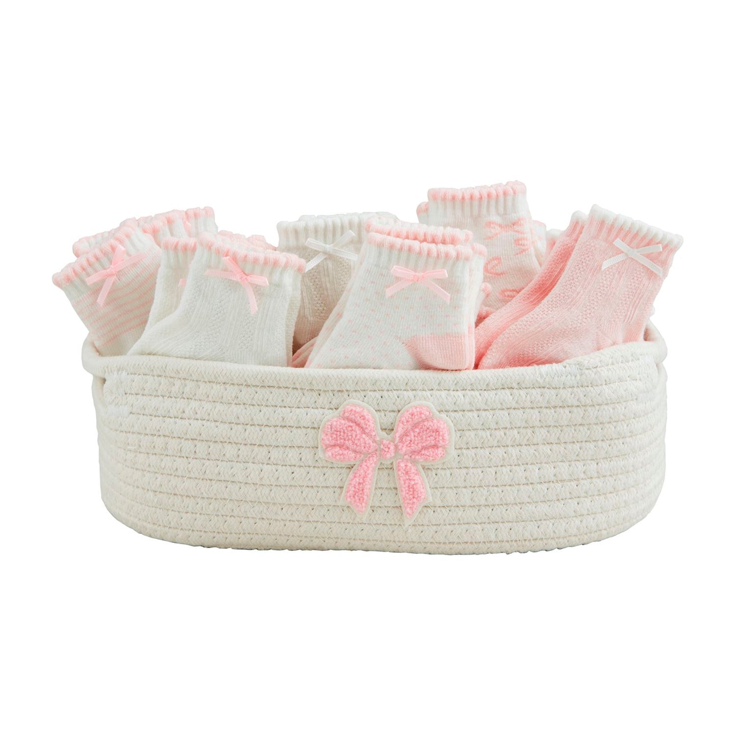 The Bow Baby Socks: Infant socks in white and pink, presented in a woven basket with a grosgrain bow. Sizes available: Newborn, 0-6 months.