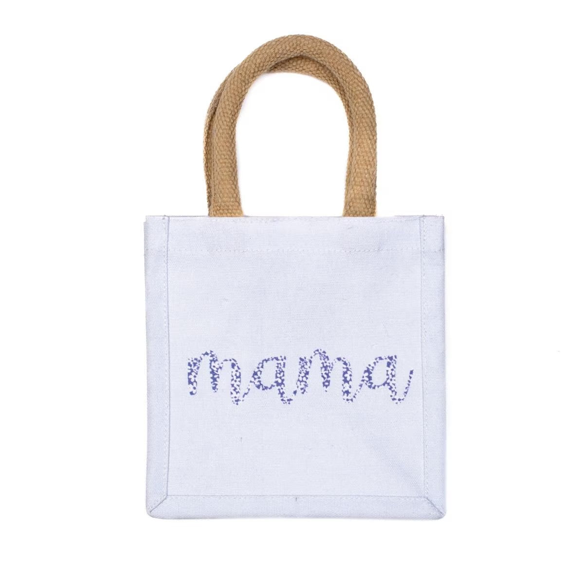 White cotton tote bag with tan woven handles, "mama" embroidered in purple flowers on front. Available size: 10" W x 8.5" H x 4.5" D.