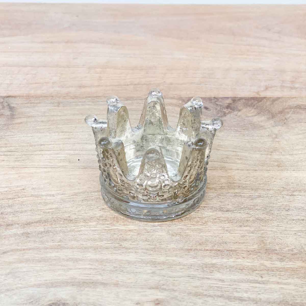 Small crown-shaped clear glass candle holder in antique silver; available in one size; clean with a soft dry cloth.