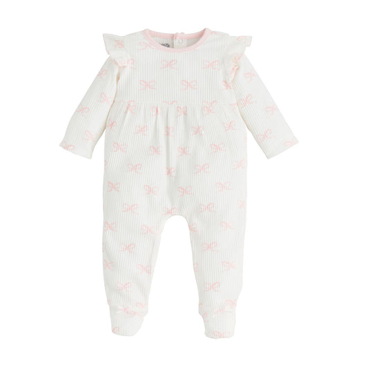 The Ruffle Bow Baby Sleeper is a white long-sleeve onesie featuring ruffled shoulders, pink bow patterns, snap buttons at the back, and a light pink-trimmed neckline. Available in sizes: Newborn, 0-3M, 3-6M, 6-9M.