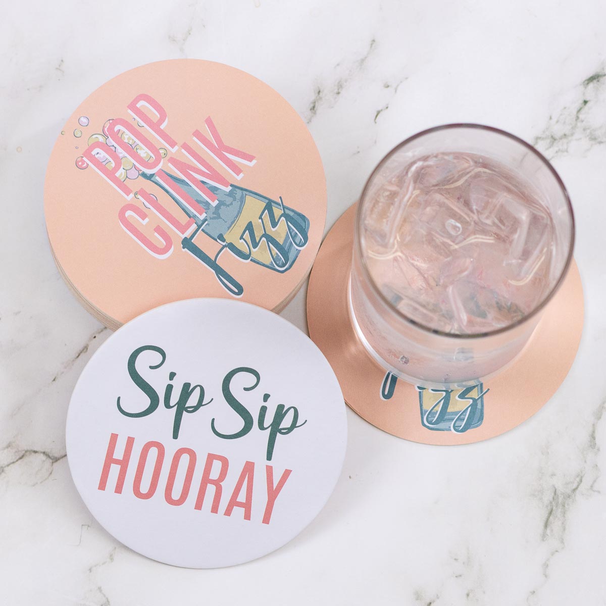 Champagne Reversible Paper Coaster, "Pop Clink Fizz" design. Festive, ideal for tablescapes. Available in 4" diameter size.