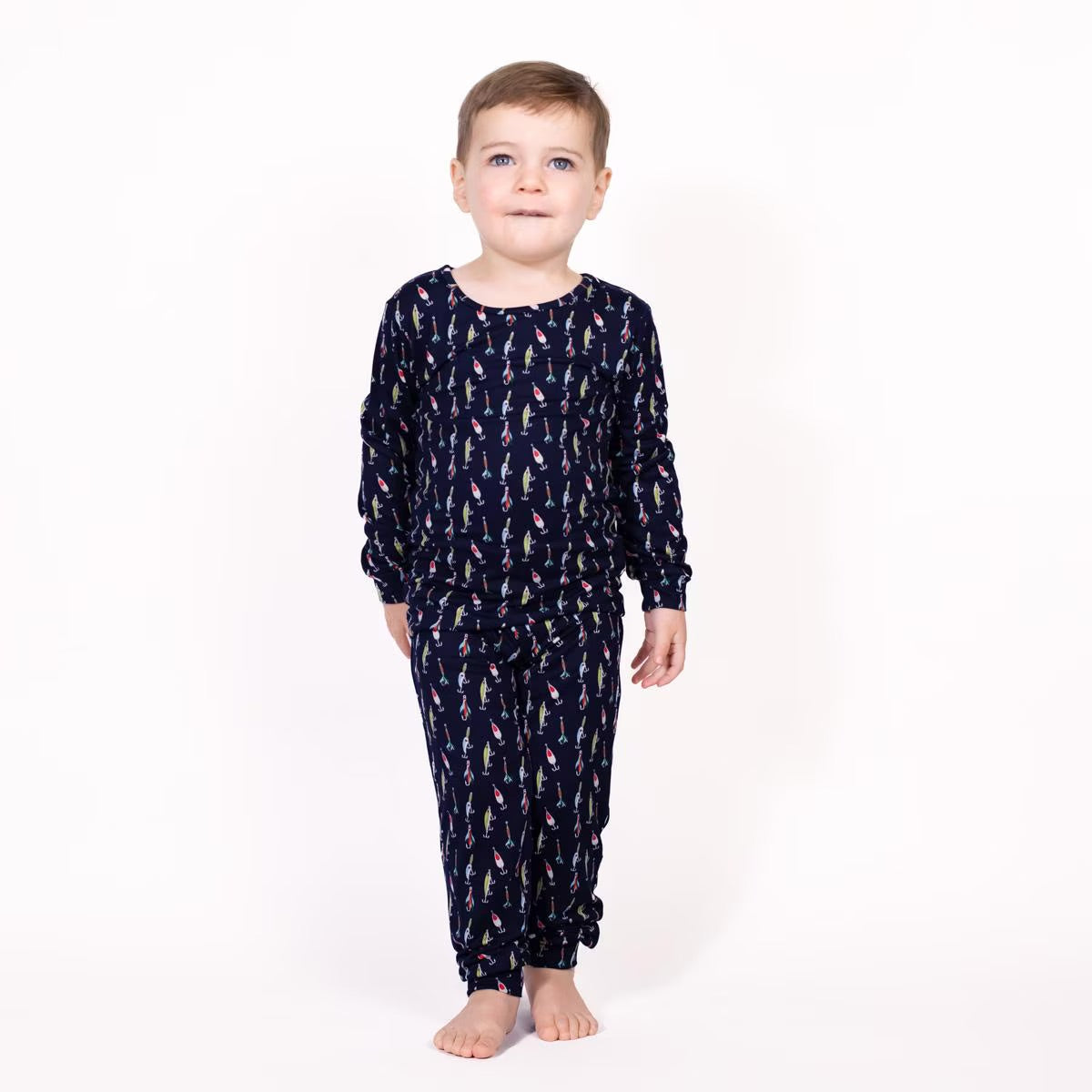 Kid's Oh Bite Me Long Sleeve Pajamas made from soft cotton; features playful shark graphics, ribbed cuffs, and an elastic waistband. Available in sizes 2T, 3T, 4T, 5T, XS (5/6), S (6/7), M (8), L (10), XL (12).