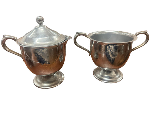 Cream and sugar set silver plated sugar has lid. Each piece is approximately 4 inches tall by 3 inches wide.
