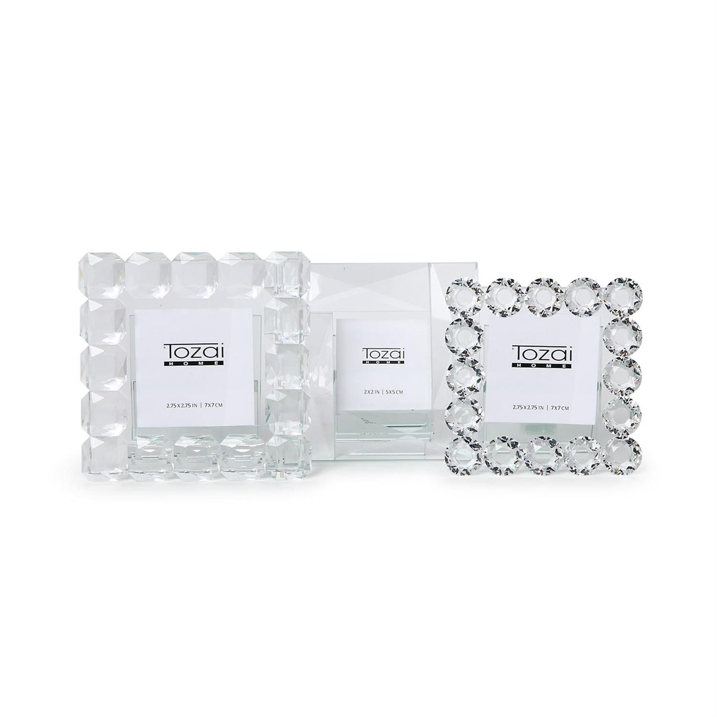 Set of three handcrafted crystal frames with faceted borders, "Tozai Home" label, available in multiple sizes.