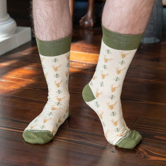 Men's Buck Socks: cream with green toes, heels, cuffs; green tree and tan fox print. Available in sizes M-XL.