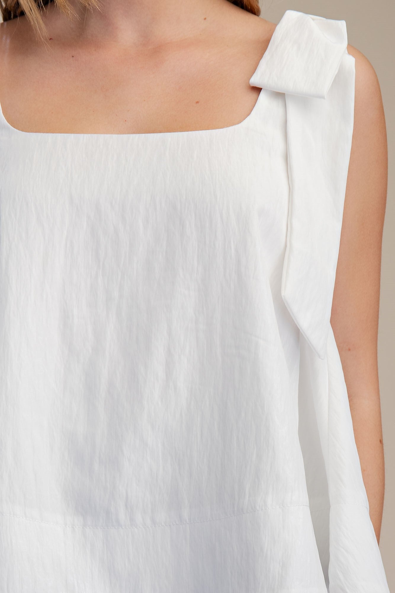 White Scoop Neck Bow Shoulder Top with textured finish, statement bow, sleeveless. Available in sizes XS-XL.
