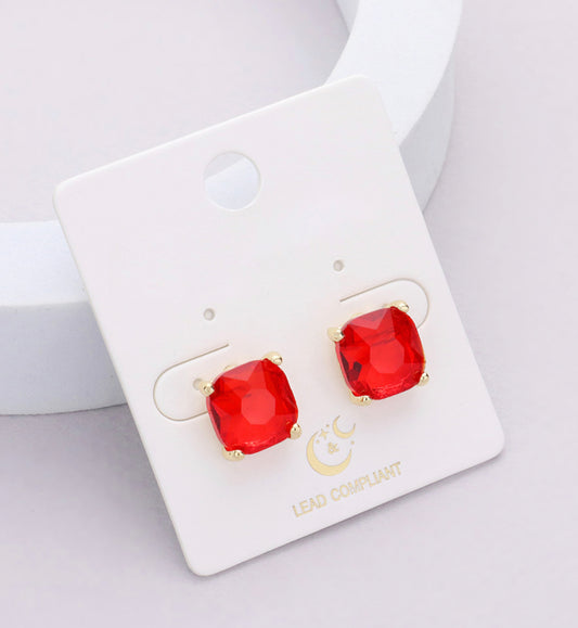 Gold-prong stud earrings with large, square-cut red gems. Sizes available: not specified.