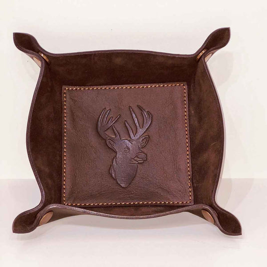 The Leather Embossed Valet Tray is a square, dark leather catchall with raised corners and an embossed deer head. Available in one size.