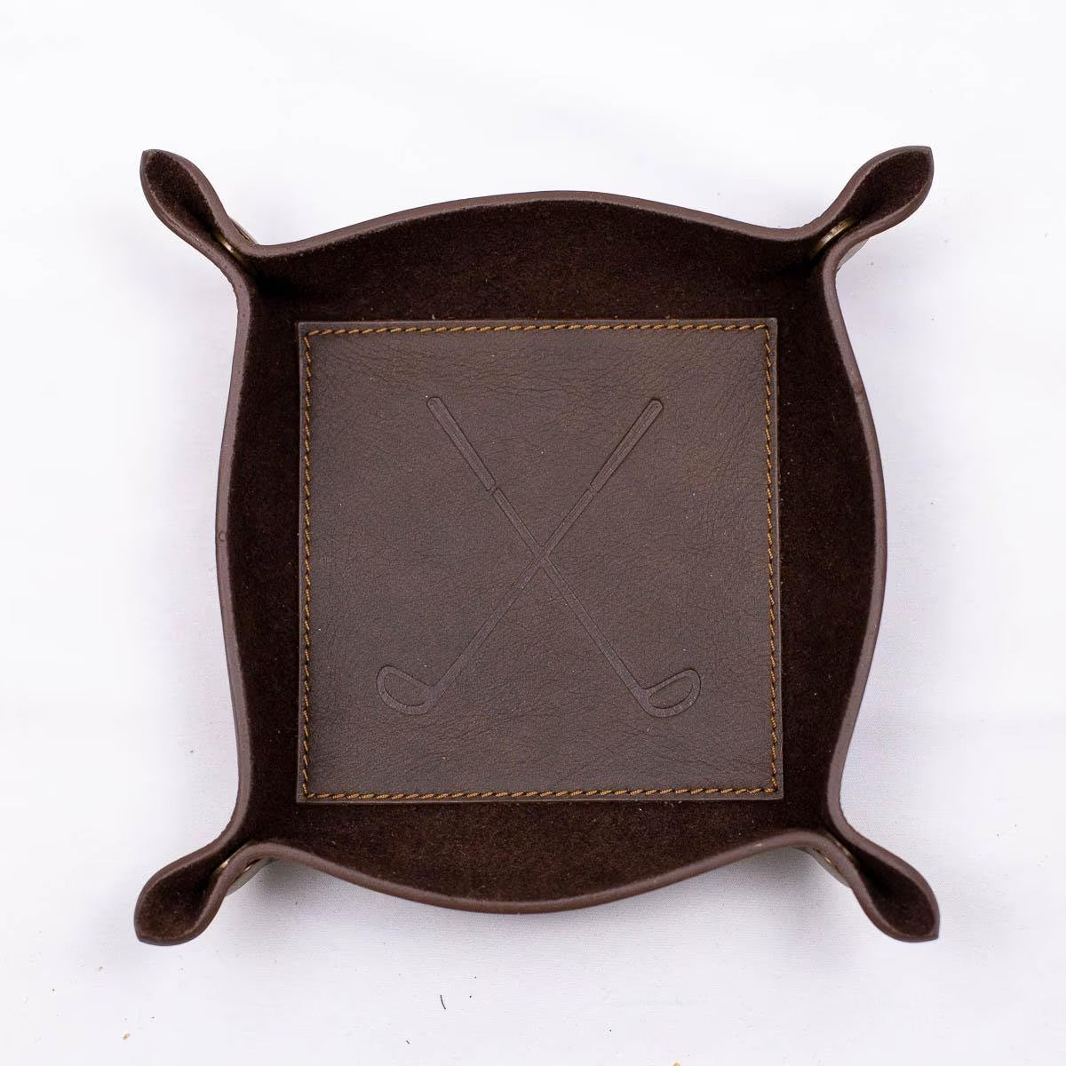 Leather Embossed Valet Tray: A nightstand catchall with raised edges, stitched corners, and crossed golf clubs at the center. Available in one size.