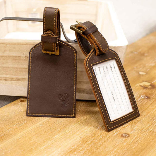 Two leather embossed luggage tags; one with logo, one with a clear ID window. Sizes: One Size.