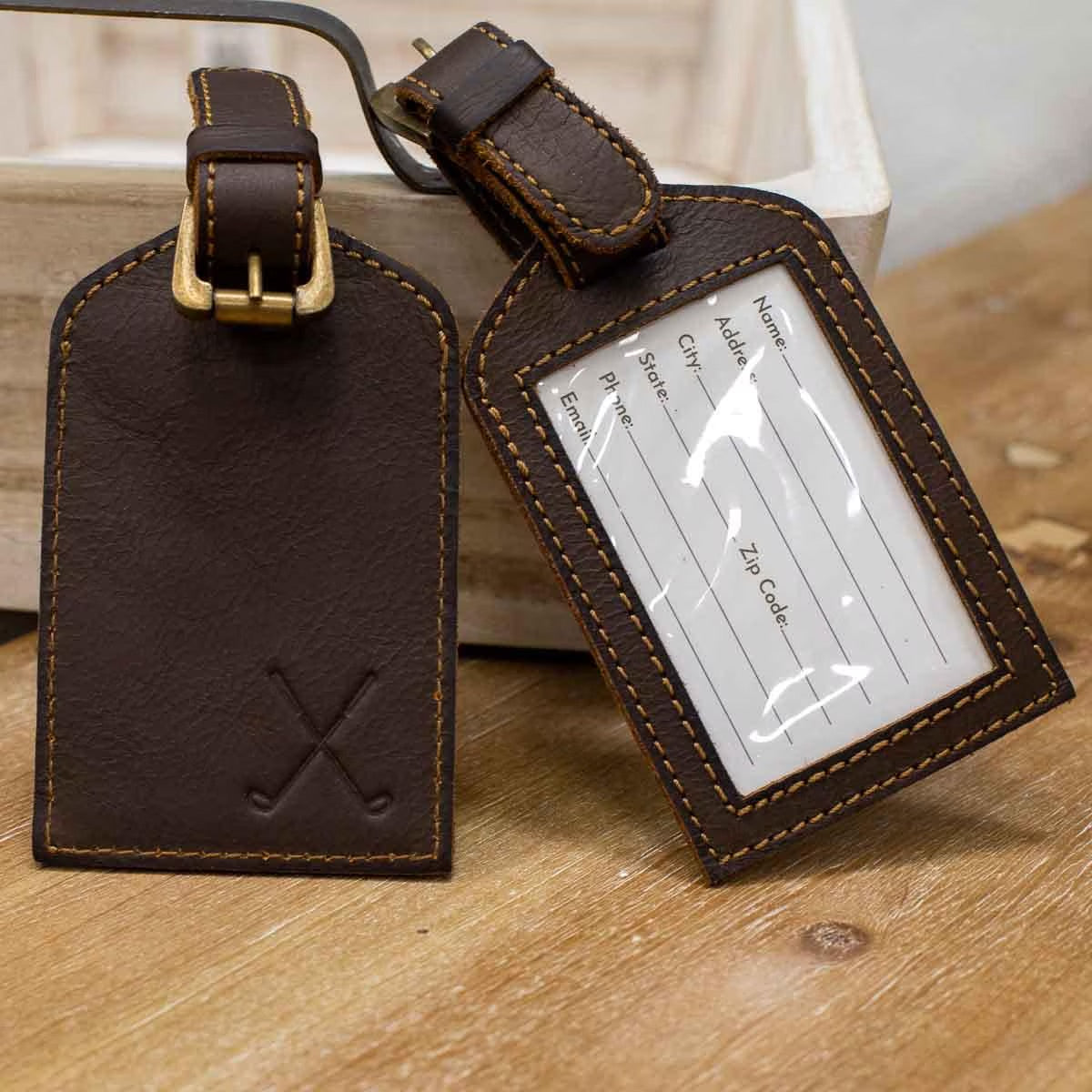 The Leather Embossed Luggage Tags are available in two designs: one with a contact info window and the other with crossed golf clubs. Made from genuine leather. Sizes: One size fits all.