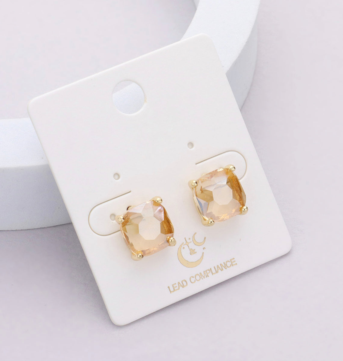 Square-cut pale yellow gemstone stud earrings in gold settings. Available sizes: small, medium, large.