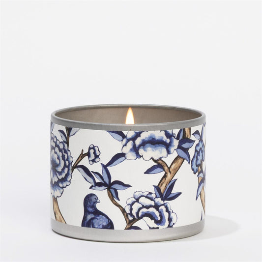 Lit Classic Linen Tin Candle with blue and white floral patterns, bird design. Available sizes: small, medium, large.