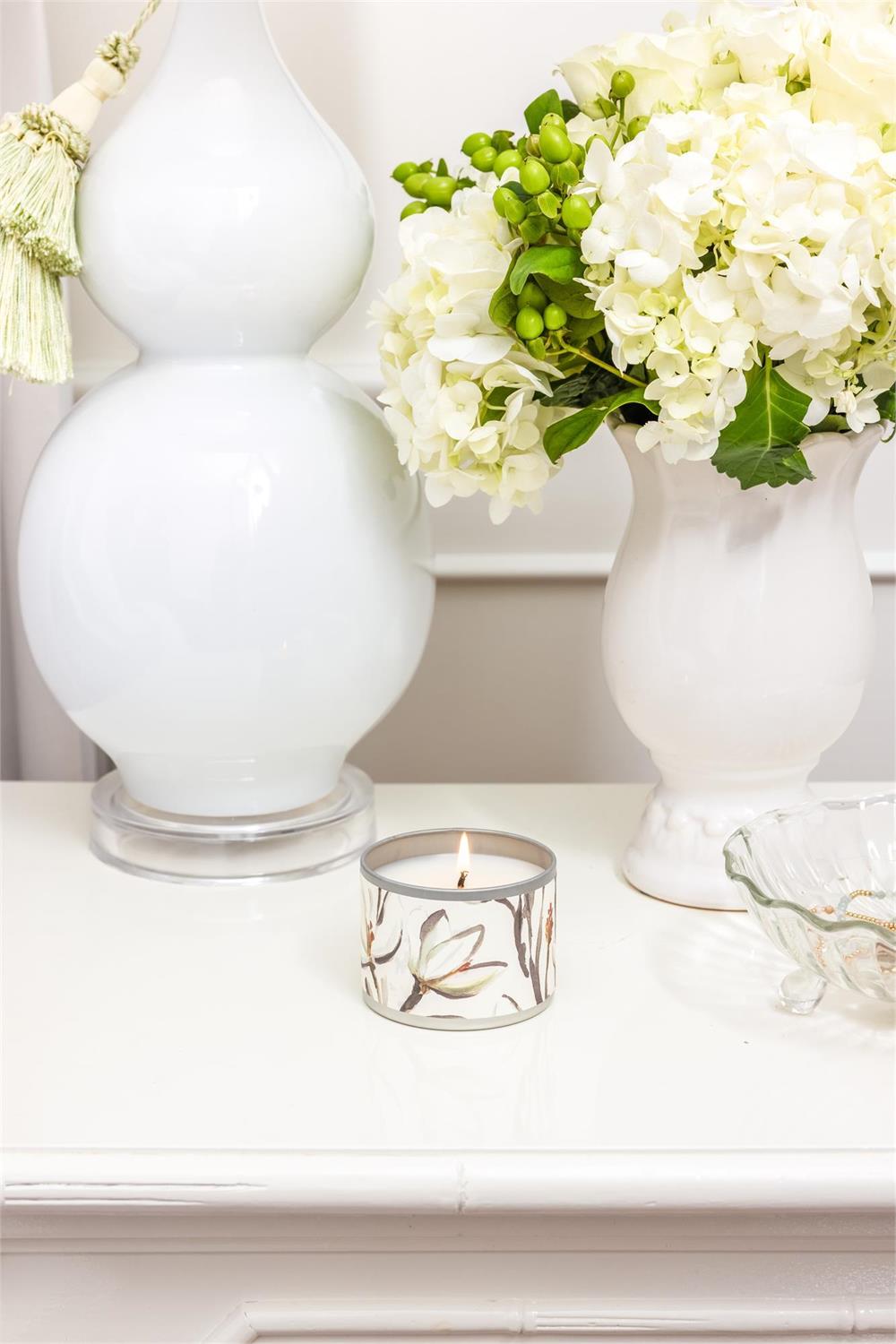 Magnolia Tin Candle with fresh magnolia scent. Available in 8oz and 16oz sizes. Simple tin design.