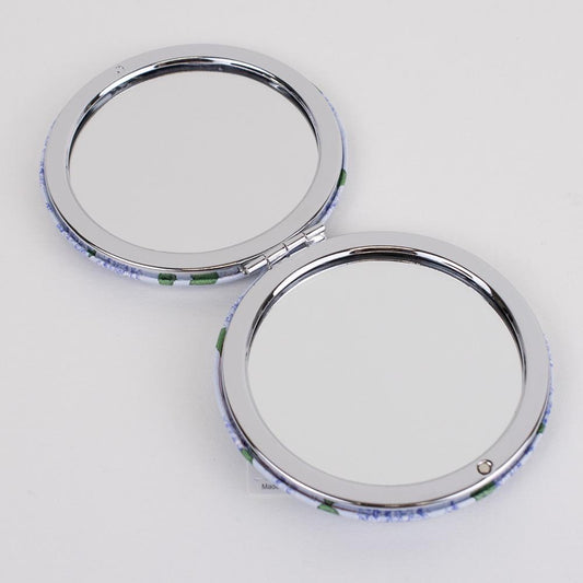 Pocket Mirror: Portable accessory, round compact design, dual mirrors. Floral pattern in blue and green. Sizes available: One size.