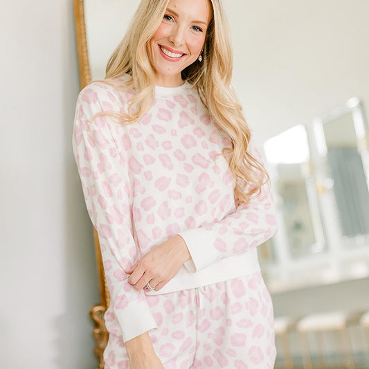 The Harriet Pajama Set features a charming pink and white heart pattern. The set includes a comfortable top and matching bottoms. Sizes available for the product range from small to extra large.