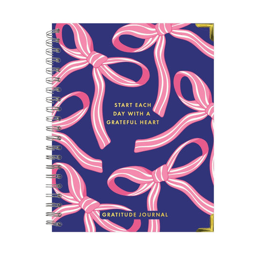 Spiral-bound navy blue Gratitude Journal with pink and white bows, gold corners, uplifting phrases; available in multiple sizes.