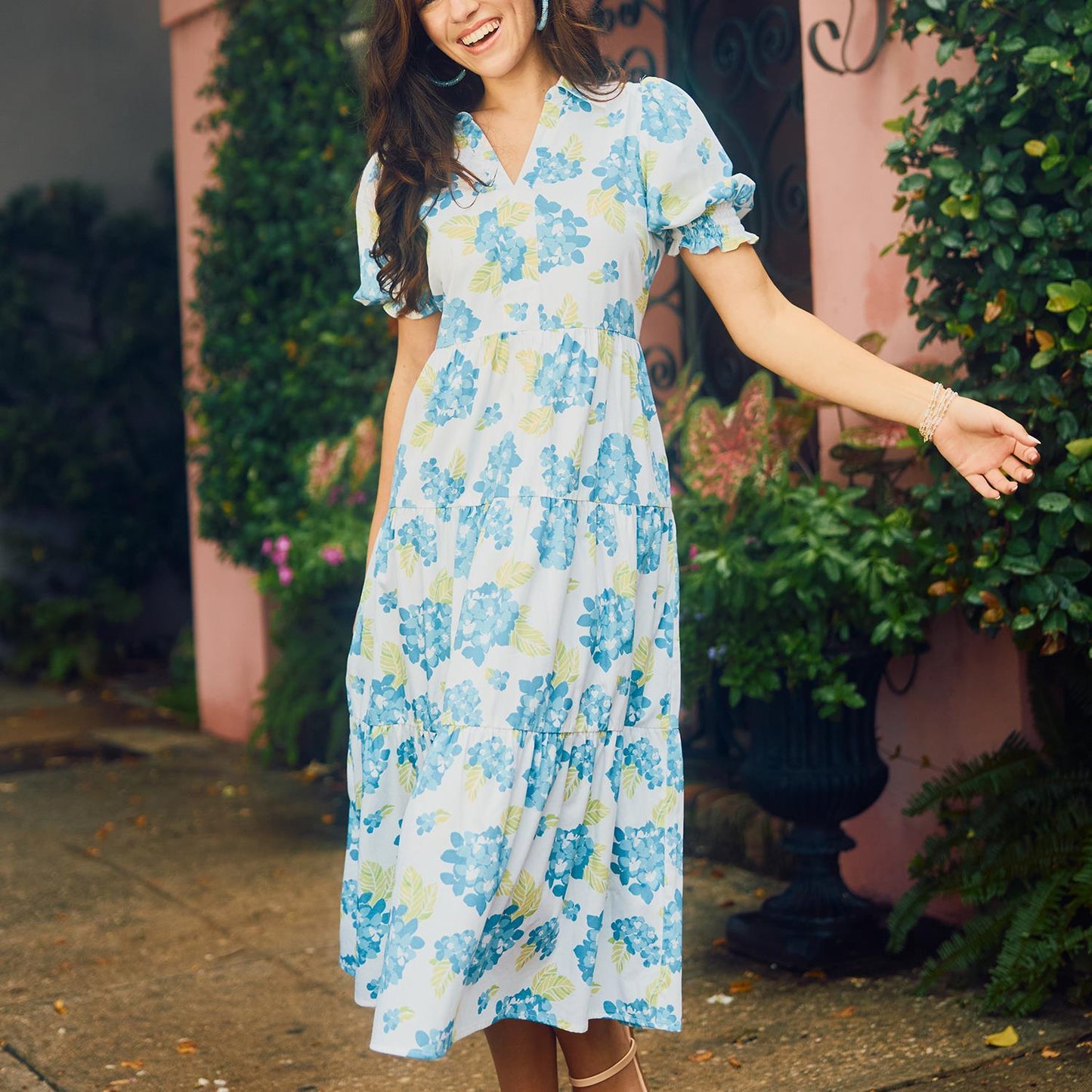 The Molly Dress features light blue and white floral patterns with smocked short puff sleeves. Available sizes: XS, S, M, L, XL.