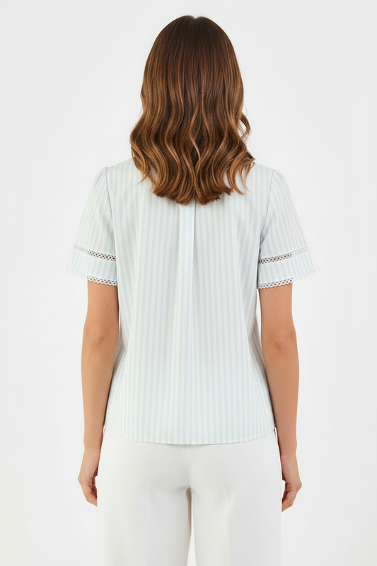 Tabby Pin Stripe Blue Top: light-colored, short-sleeve blouse with decorative lace trim. Available in sizes XS–XL.