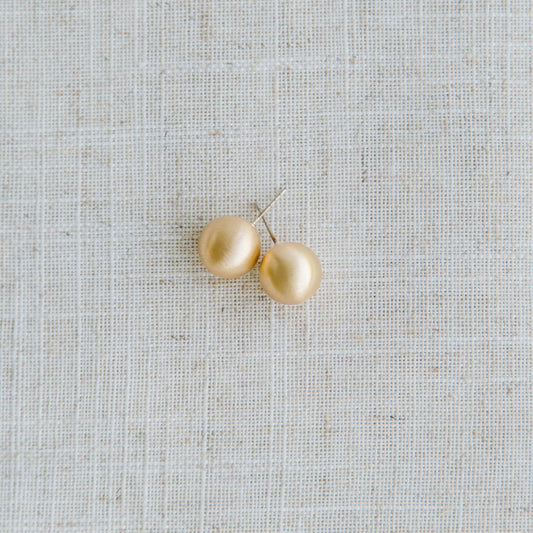Round gold Grenada Earrings with hypoallergenic surgical steel posts. Available in small, medium, and large sizes.