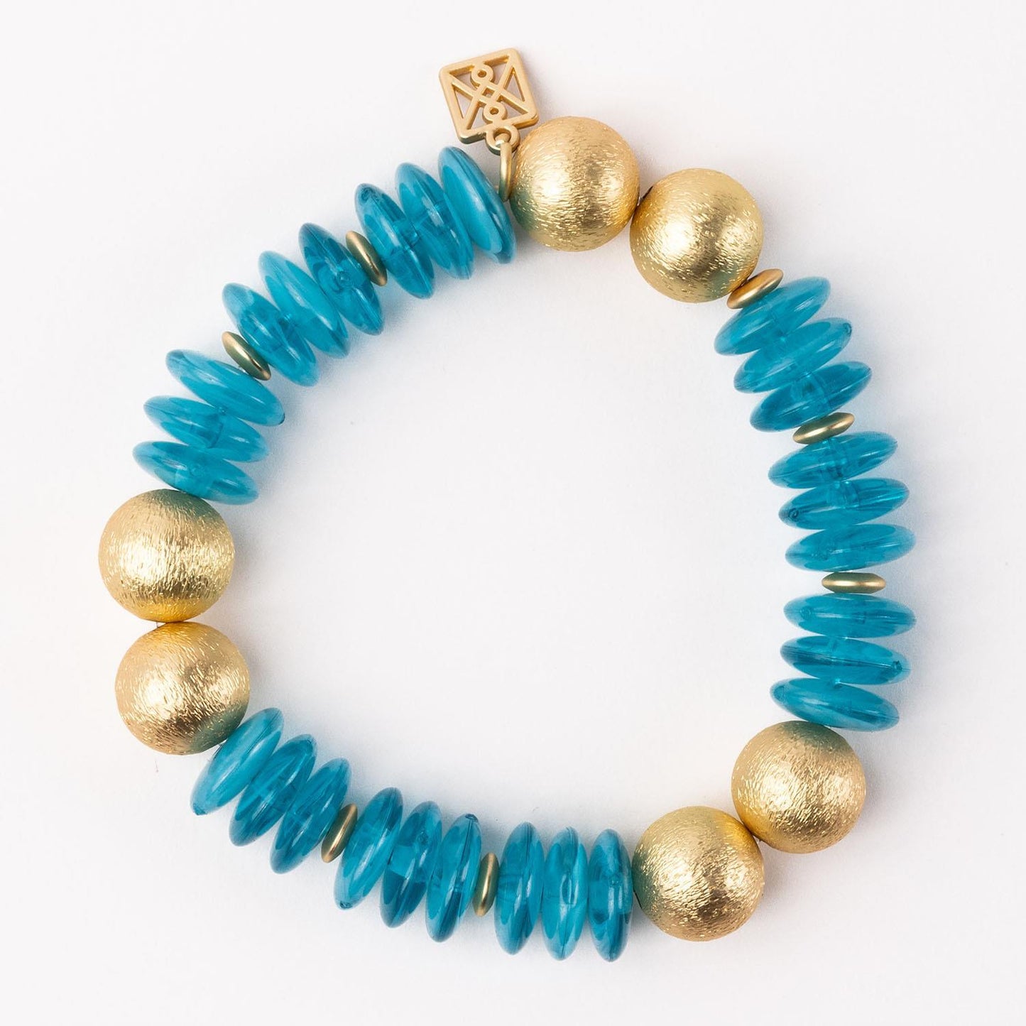 The James Bracelet: textured gold round beads, turquoise disc beads, gold spacers, geometric gold square charm. Sizes available.