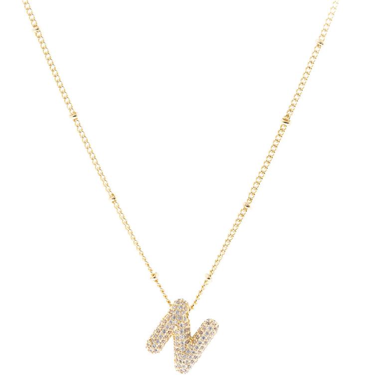 The Chloe Necklace has a gold chain with small, evenly spaced links and an "N"-shaped pendant encrusted with diamonds. Available in one size.