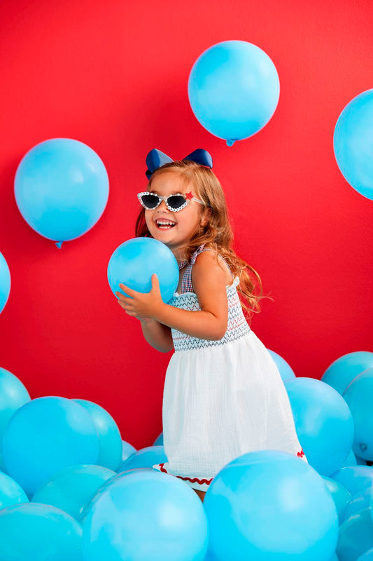 White Smocked Gauze Toddler Dress: A charming dress featuring elegant smocking, perfect for playful occasions. Sizes available: 2T, 3T, 4T, and 5T.