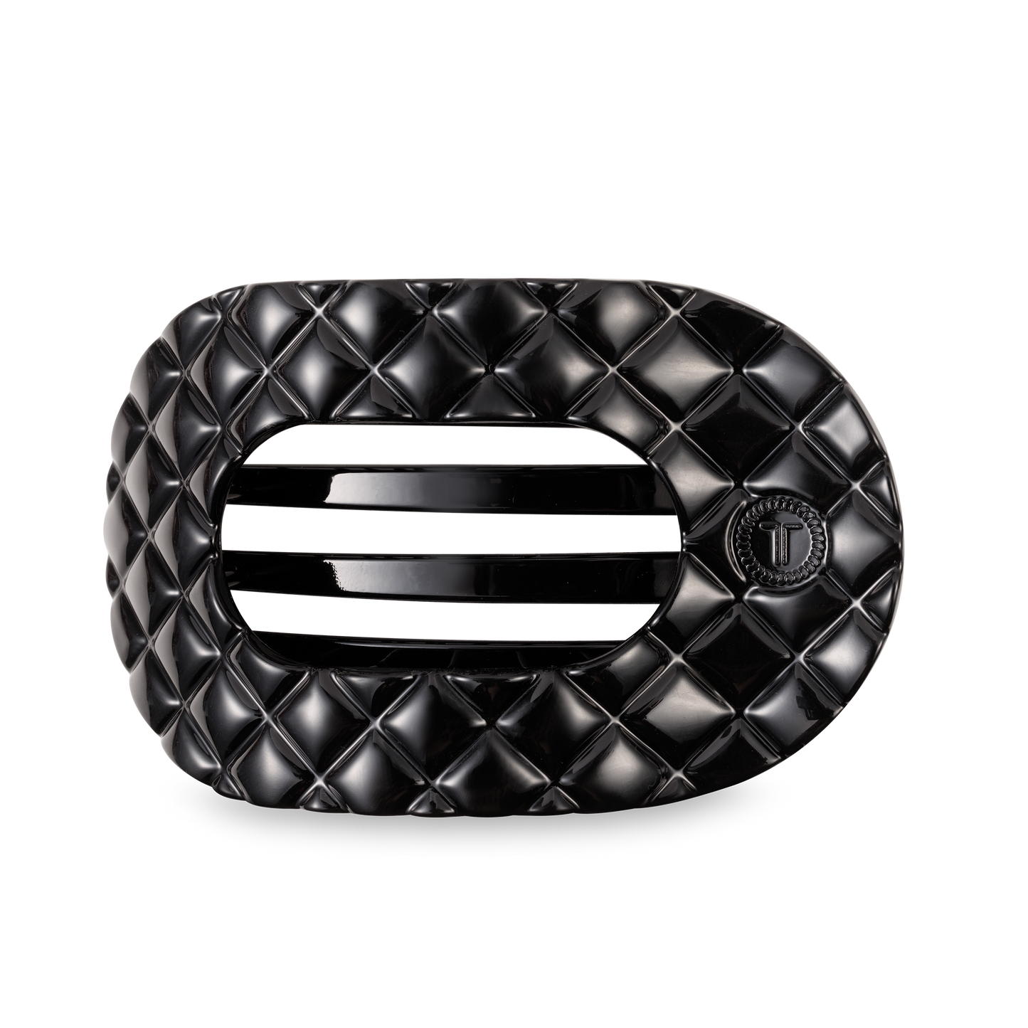 Black oval TELETIES Flat Round Hair Clip with quilted pattern, slats, "T" emblem; available in large and small sizes.