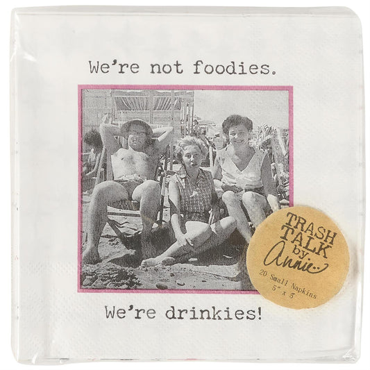 Retro-style disposable napkin, "We're not foodies. We're drinkies!" with "TRASH TALK by Annie" label. Available in cocktail size.