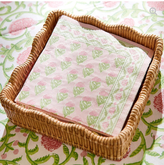 Floral Block Print Paper Napkins, green and pink design, stacked in a square wicker basket. Available sizes: 6"x6", 7"x7".
