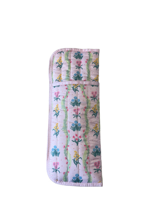 Quilted pouch with pink, green, and yellow floral pattern on white; protects hot styling tools. Available in small and large.