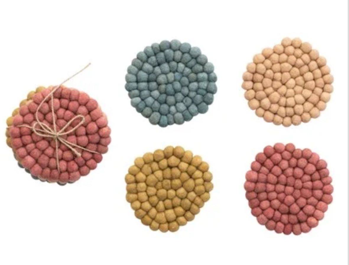 Handmade wool felt ball coasters in pink, blue, beige, yellow, and red. Available in round; sizes: 4", 5", and 6".