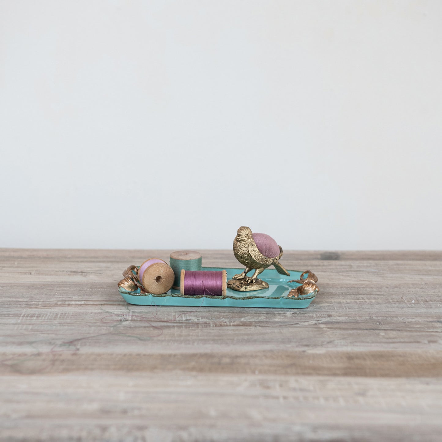 Decorative gold-finish metal tray with bows. Available in small, medium, and large sizes.