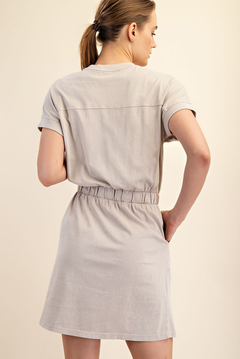 Mineral Washed Elastic Waist Cotton Dress in light beige. Features an elastic waistband, mini length, and turned-up sleeves. Sizes available: S, M, L.