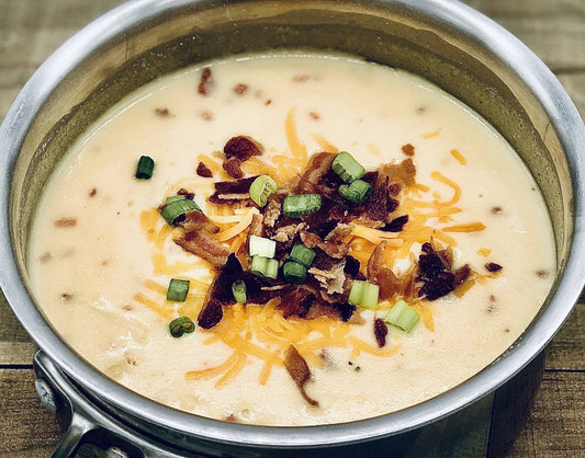 Loaded Baked Potato Soup Mix in a pot with cheese, green onions, bacon bits. Available in 12oz and 24oz sizes.