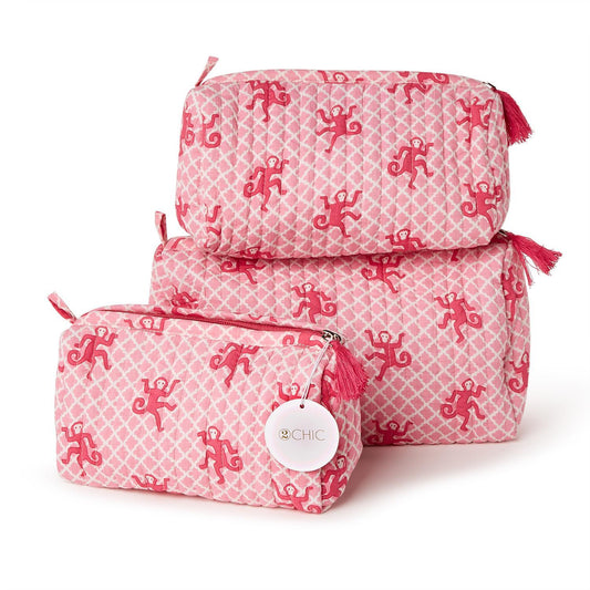 Set of 3 pink cotton quilted cosmetic bags with red monkey print, red tassels, waterproof lining; available in small, medium, large.